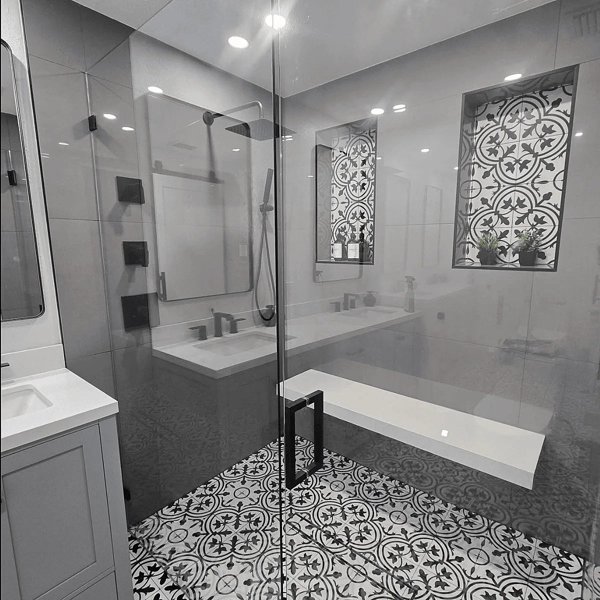Patterned tile floor and glass shower enclosure