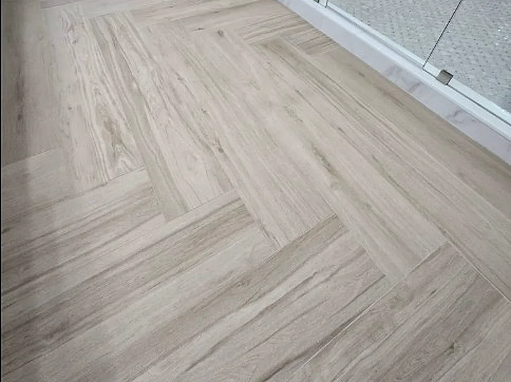 Herringbone wood-look plank tile flooring